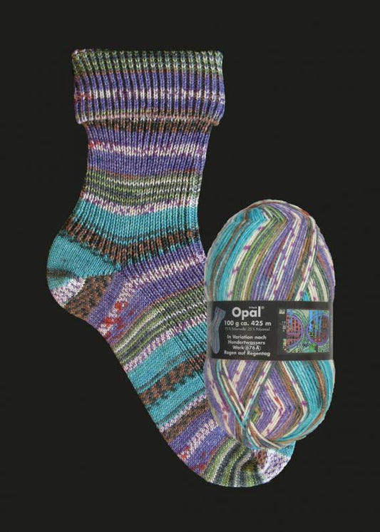 Colourful artist inspired  striped sock yarn in purple green and blue with Opal label on a black background. 