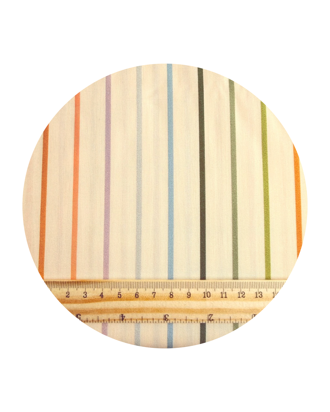 A round swatch of Tiny Stripe Pearl from Slow Summer Collection by Art Gallery Fabrics, with a wooden ruler showing centimeters for scale, on a white background.