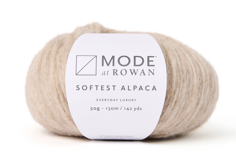 ball of light oatmeal yarn with a mode at rowan label on a white background.