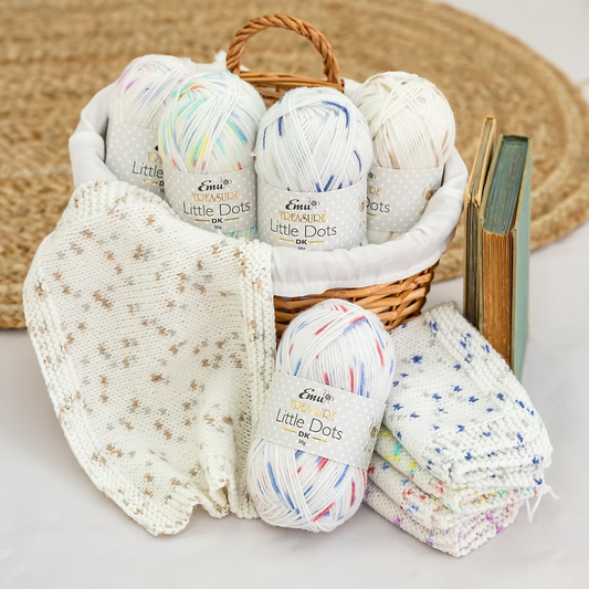 image of basket filled with assortment of little dots yarns and knitted sample.