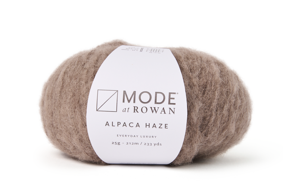 brown fluffy yarn on plain white background and mode at rowan label with grey writing.