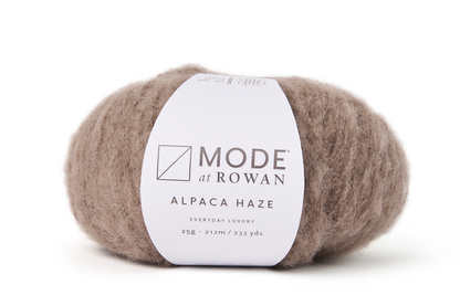 brown fluffy yarn on plain white background and mode at rowan label with grey writing.