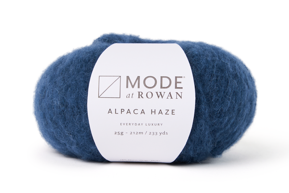blue skein of fluffy yarn with mode at rowan label with grey writing on a plain white background.
