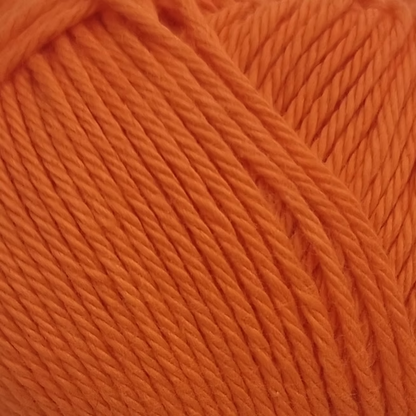 close up of orange ball of cotton  yarn. bright orange wool. 