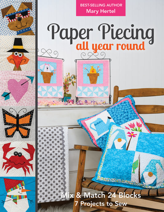 Book cover of 'Paper Piecing all year round' with quilted blocks and pillows. ey