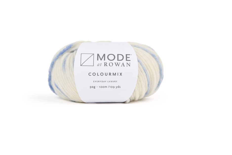 Ball of cream and blue yarn with mode at rowan label on a plain white background. 