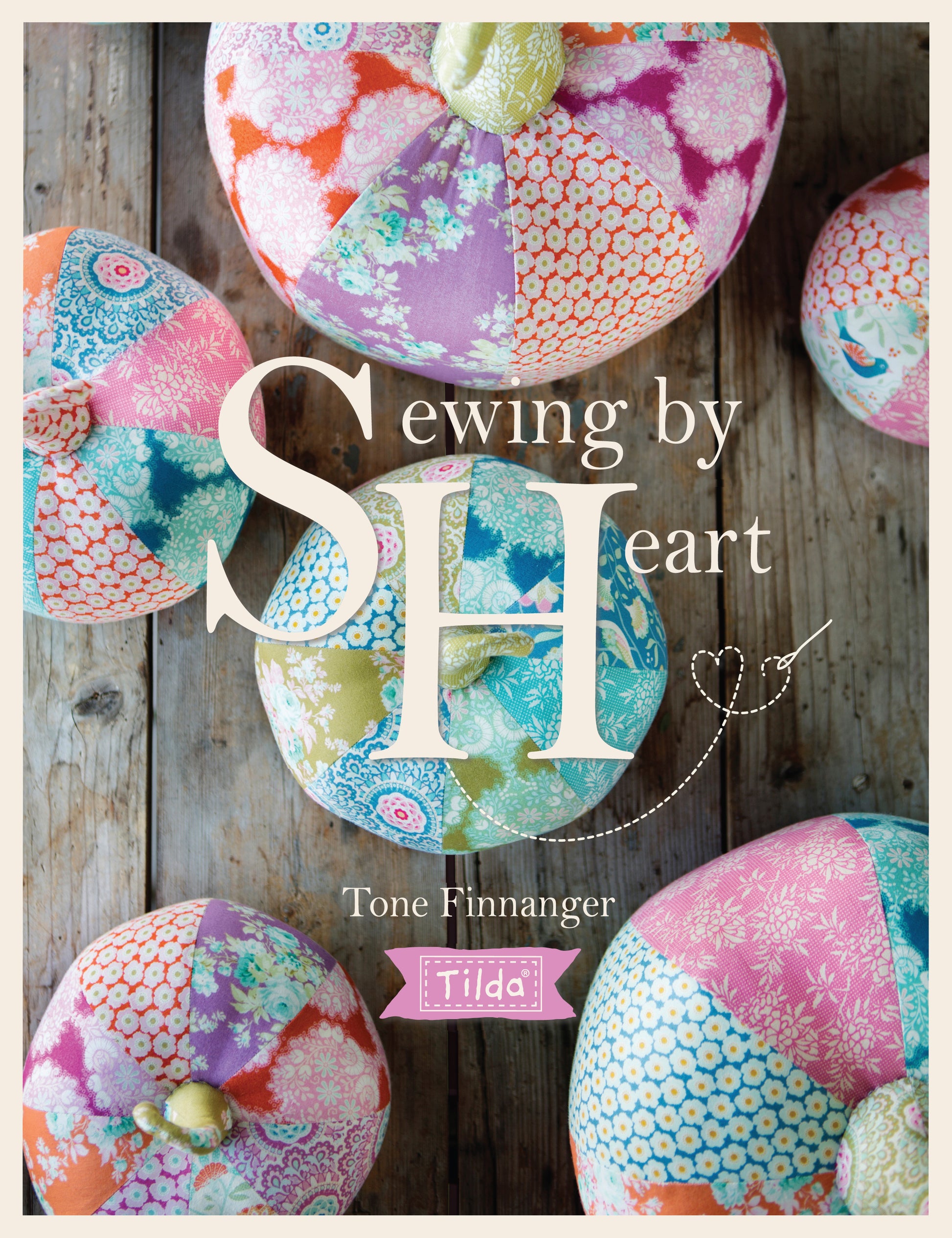 book cover of 'sewing by heart' by Tone Finnanger with Tilda branding and as assortment of sewn items in a variety of colours.
