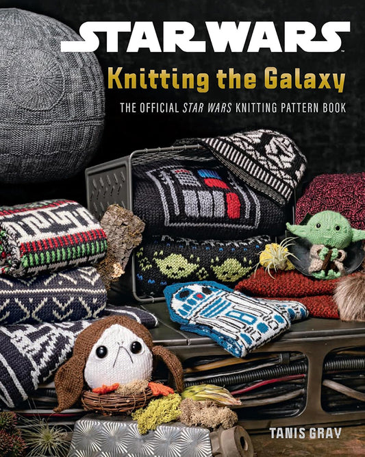 Knitted items inspired by Star Wars with a book titled 'Star Wars: Knitting the Galaxy' on a dark background.