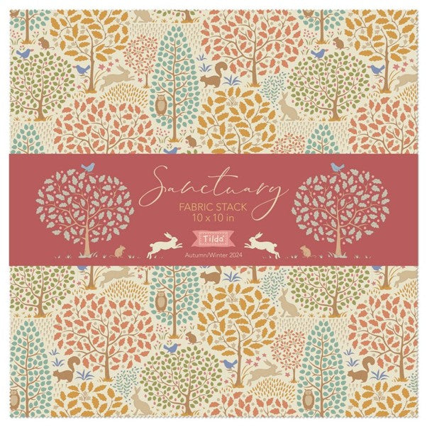 A fabric stack of 10" x 10" squares by Tilda  with an autumn woodland pattern with trees, birds, squirrels, and rabbits in muted colours of beige, orange, teal, and brown, photographed against a white background.  