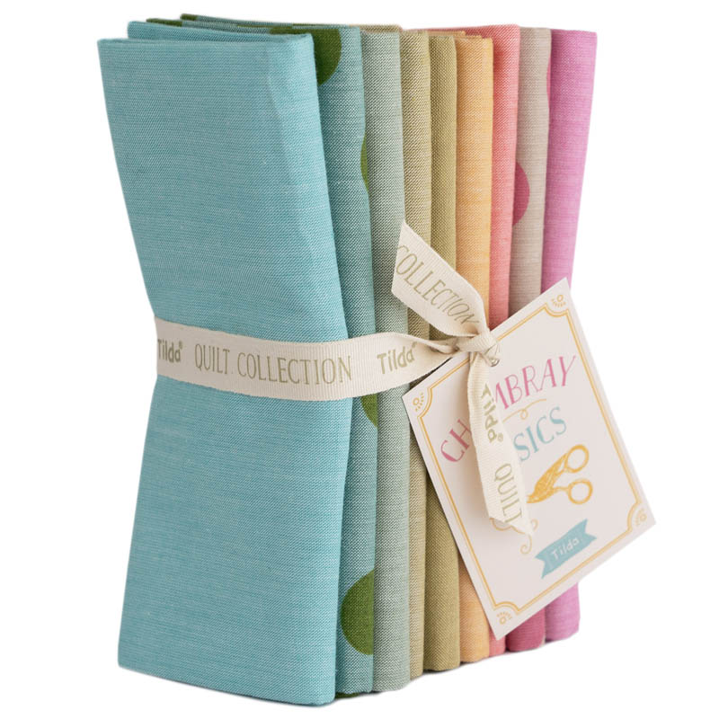 Pack of 9 fat quarters by Tilda in spring colours, photographed against a white background.