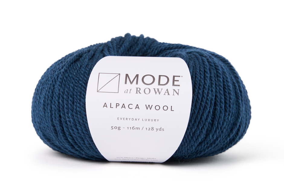 ball of blue yarn with mode at rowan label of a white background. 