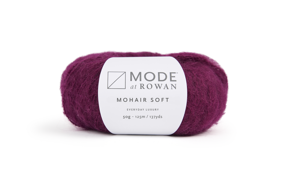 ball of purple yarn with mode at rowan label with grey writing.  on a plain white background.