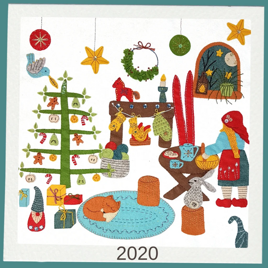 stitched felt scene with a Christmas tree, ornaments, and people in festive attire, featuring the year 2020.