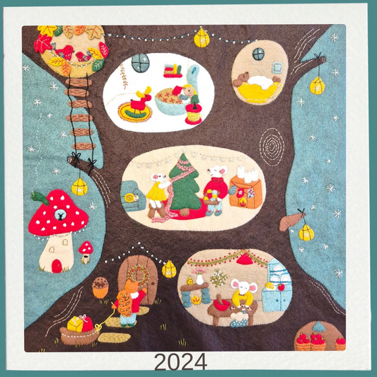felt embroidered tree with various scenes and characters, featuring the year 2024.