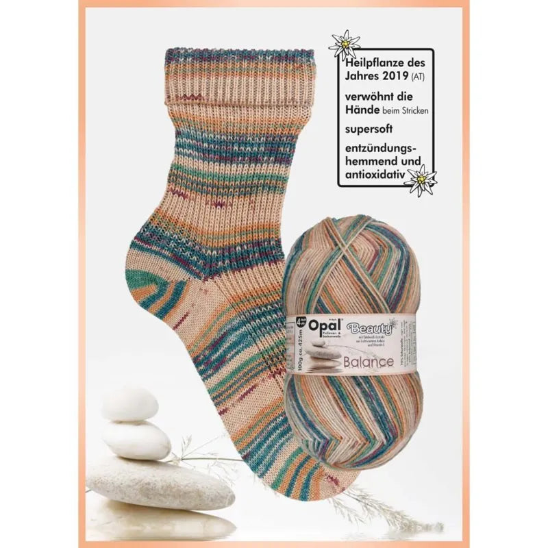 Knitted sock and ball of yarn with neutrals blue  green ,with Opal brand label on a white background 