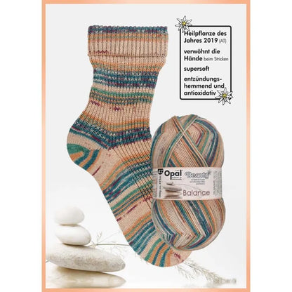 Knitted sock and ball of yarn with neutrals blue  green ,with Opal brand label on a white background 