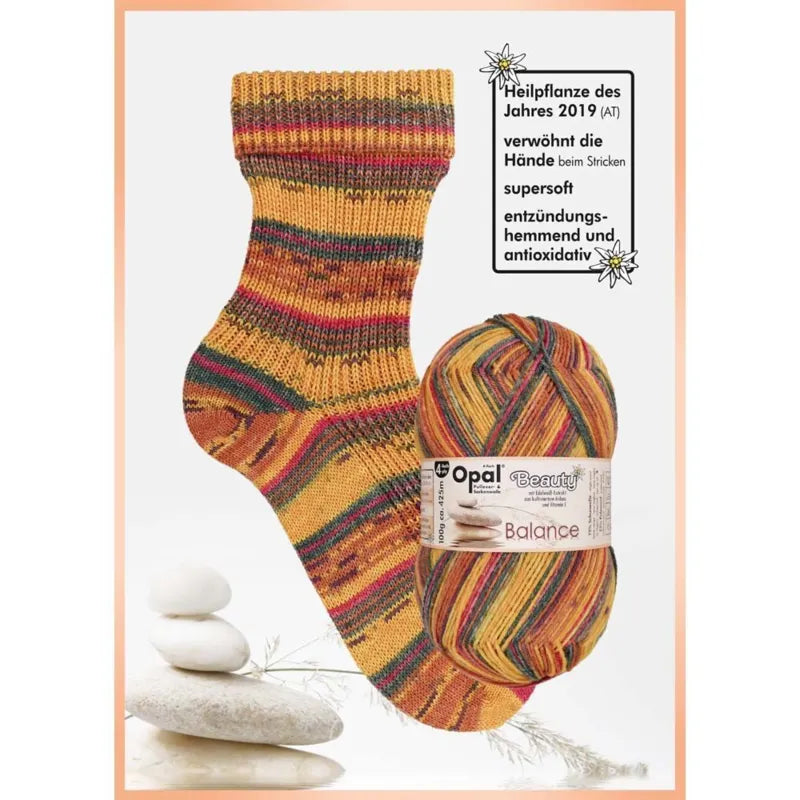 Knitted sock and ball of yarn with Opal brand label on a white background