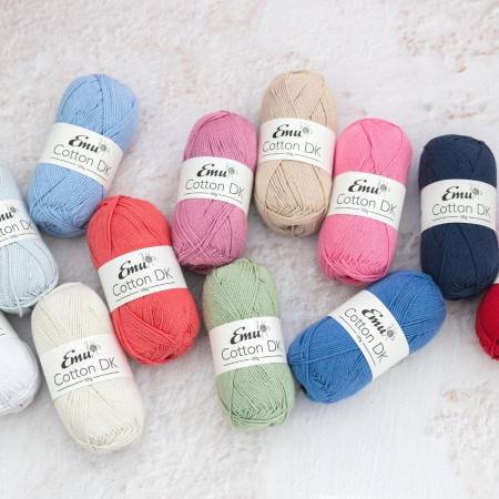 Assorted colours of Emu Cotton DK yarn on a textured surface. 