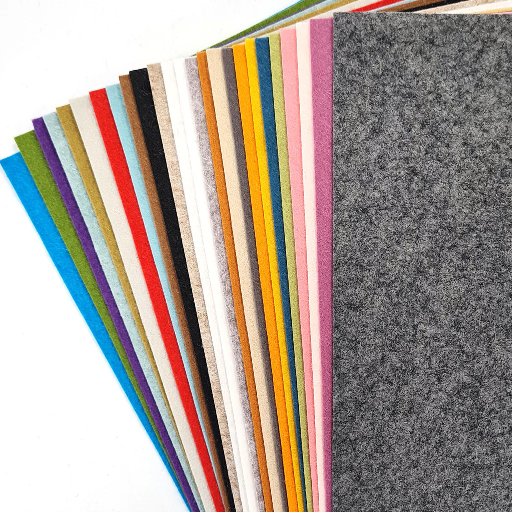collection of coloured wool mix felt displayed on a white surface.  