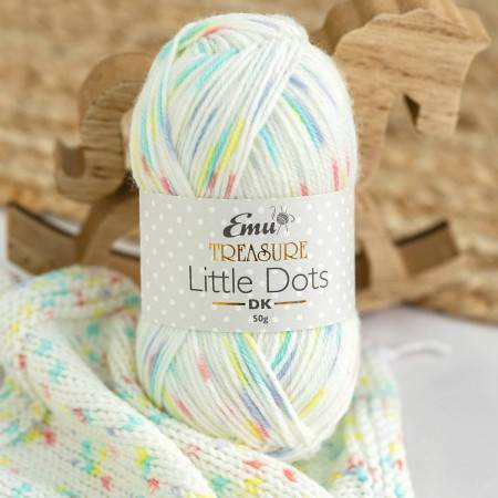 ball of white yarn with blue, yellow and red dots throughout it.