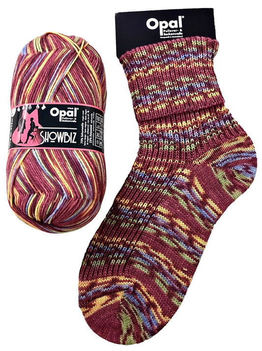 Opal Showbiz yarn ball and sock with multicolour in burgundy  yellow and green pattern on a white background.  