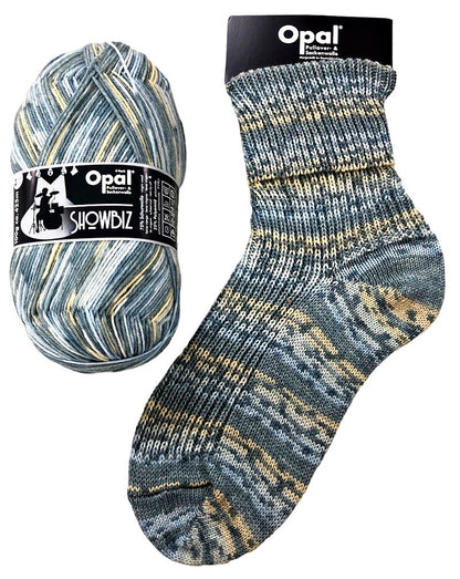 Opal Showbiz yarn ball and sock in neutral tones of blue grey and yellow on a white background 