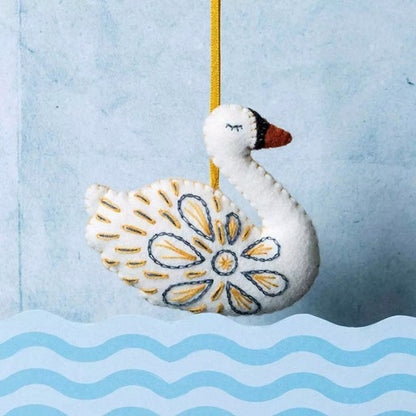 decorative embroidered felt swan on blue background.